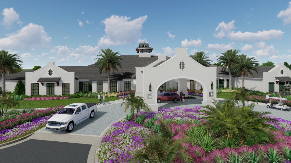 Elegant entrance to a modern building with palm trees and vibrant landscaping.